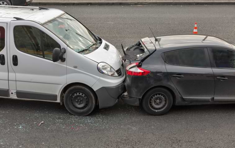 Two cars involved in rear-end car accident a city street 