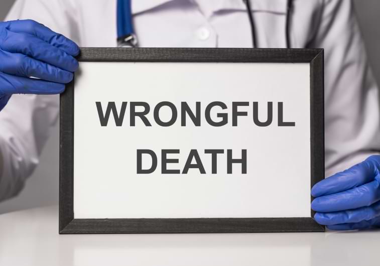 Medical doctor holding up a sign that says wrongful death 