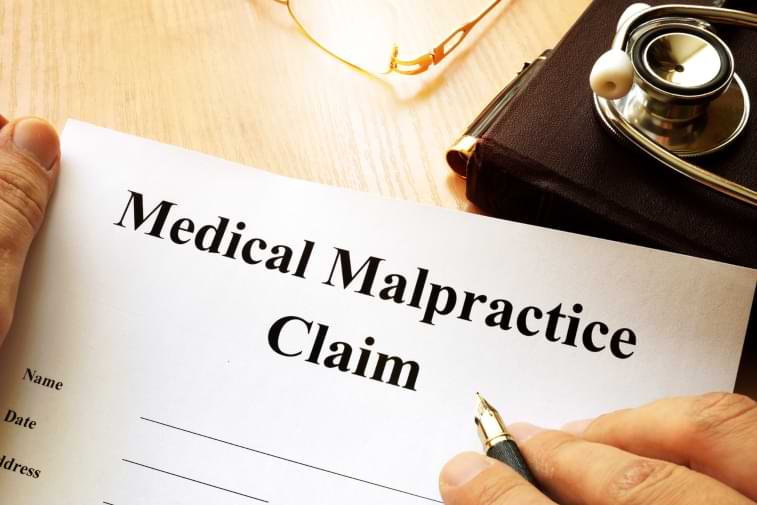 A man holding medical malpractice claim form 